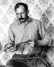 Period portrait of Tom Horn in dark suit and hat, photographed in his cell while awaiting execution in Cheyenne, Wyoming, 1903.