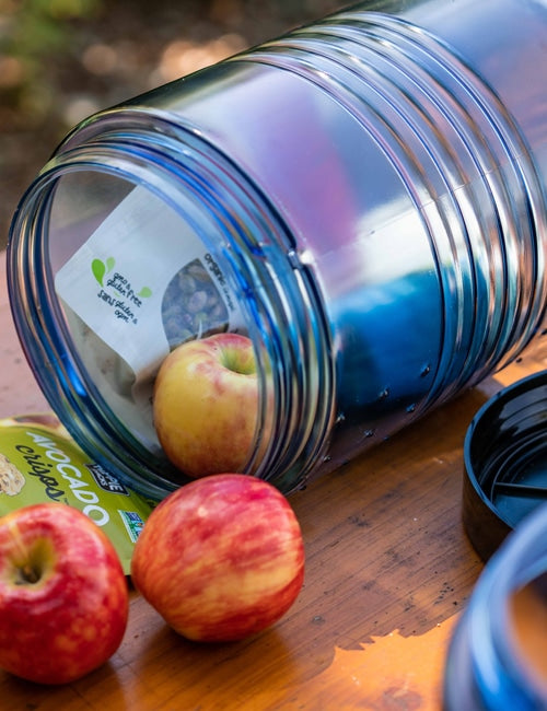 BearVault BV500 clear polycarbonate bear canister with black screw-on lid, showing food visible inside