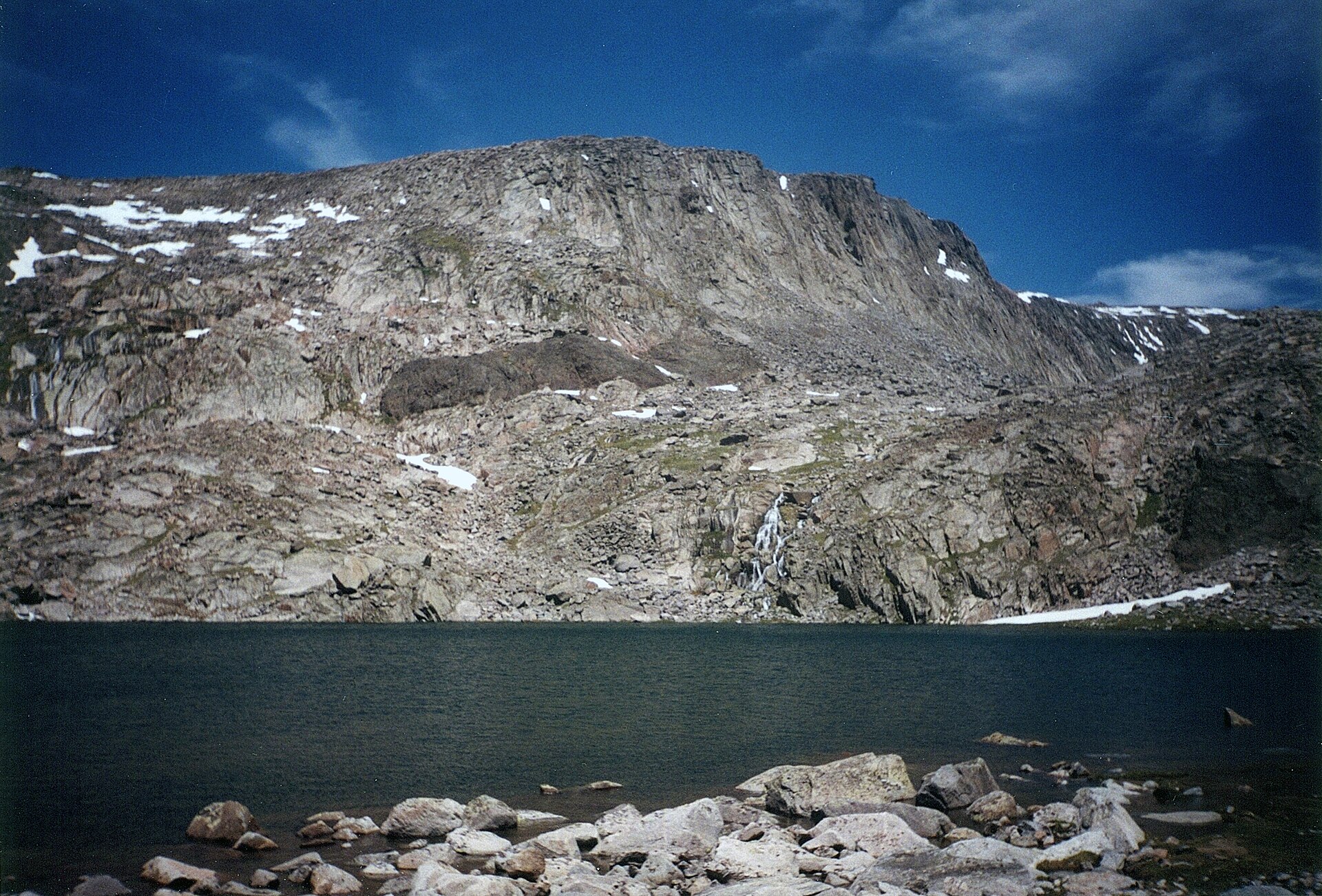 Pack horses loaded with panniers and tarped manties on a switchback trail above tree line in the Cloud Peak Wilderness, Bighorn Mountains, Wyoming.
