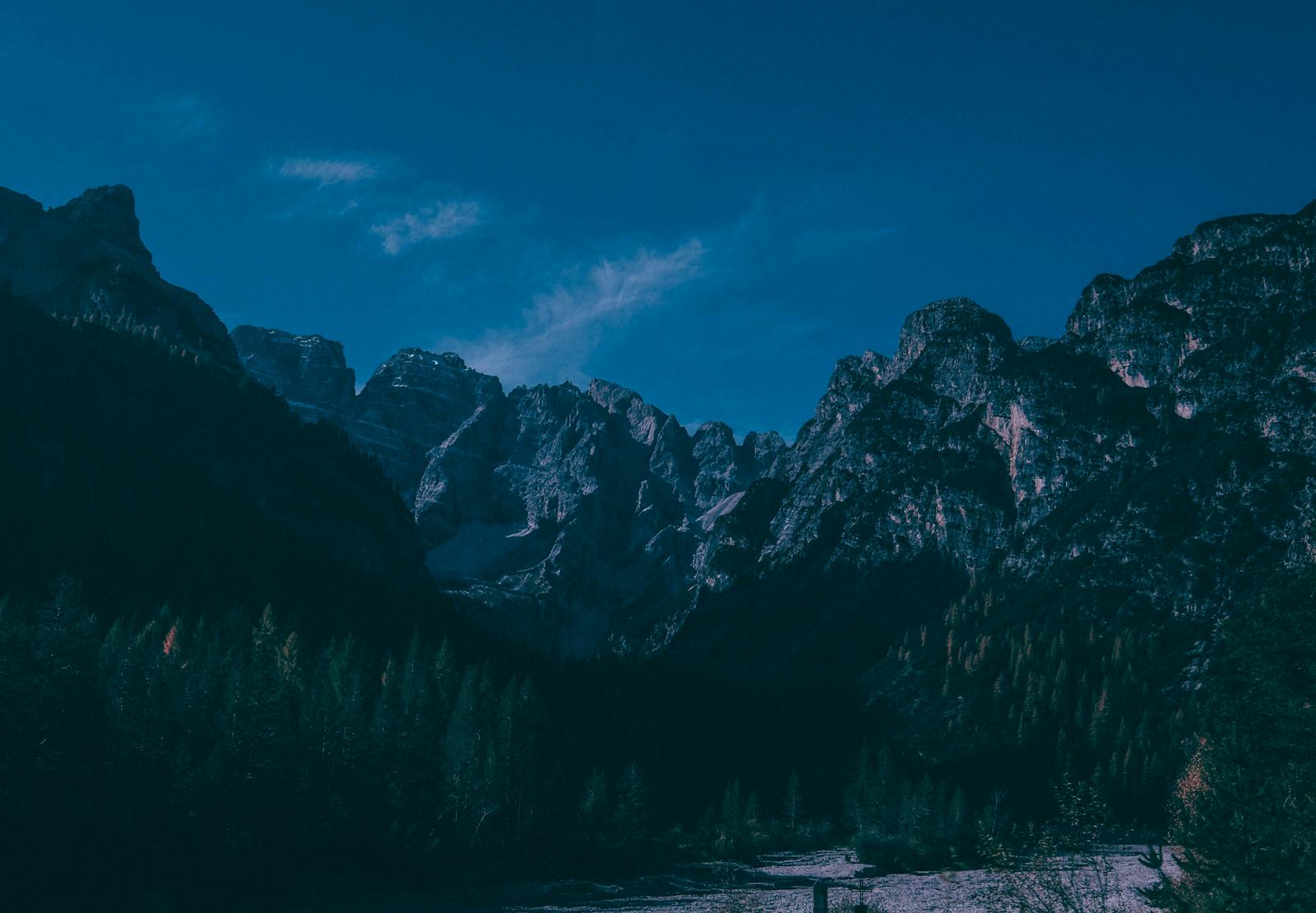 Mountain canyon with river running through evergreen forest.