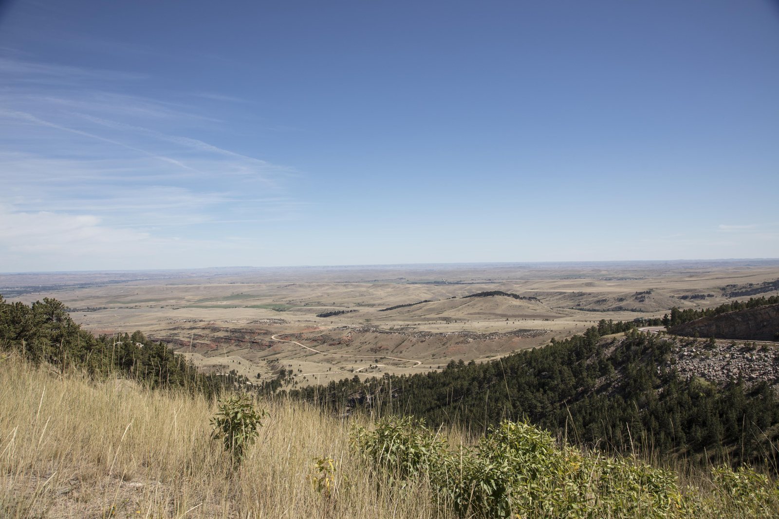 A view from a grassy Bighorn foothill ridge out across dry rolling rangeland toward the open plains, Sheridan County, Wyoming.