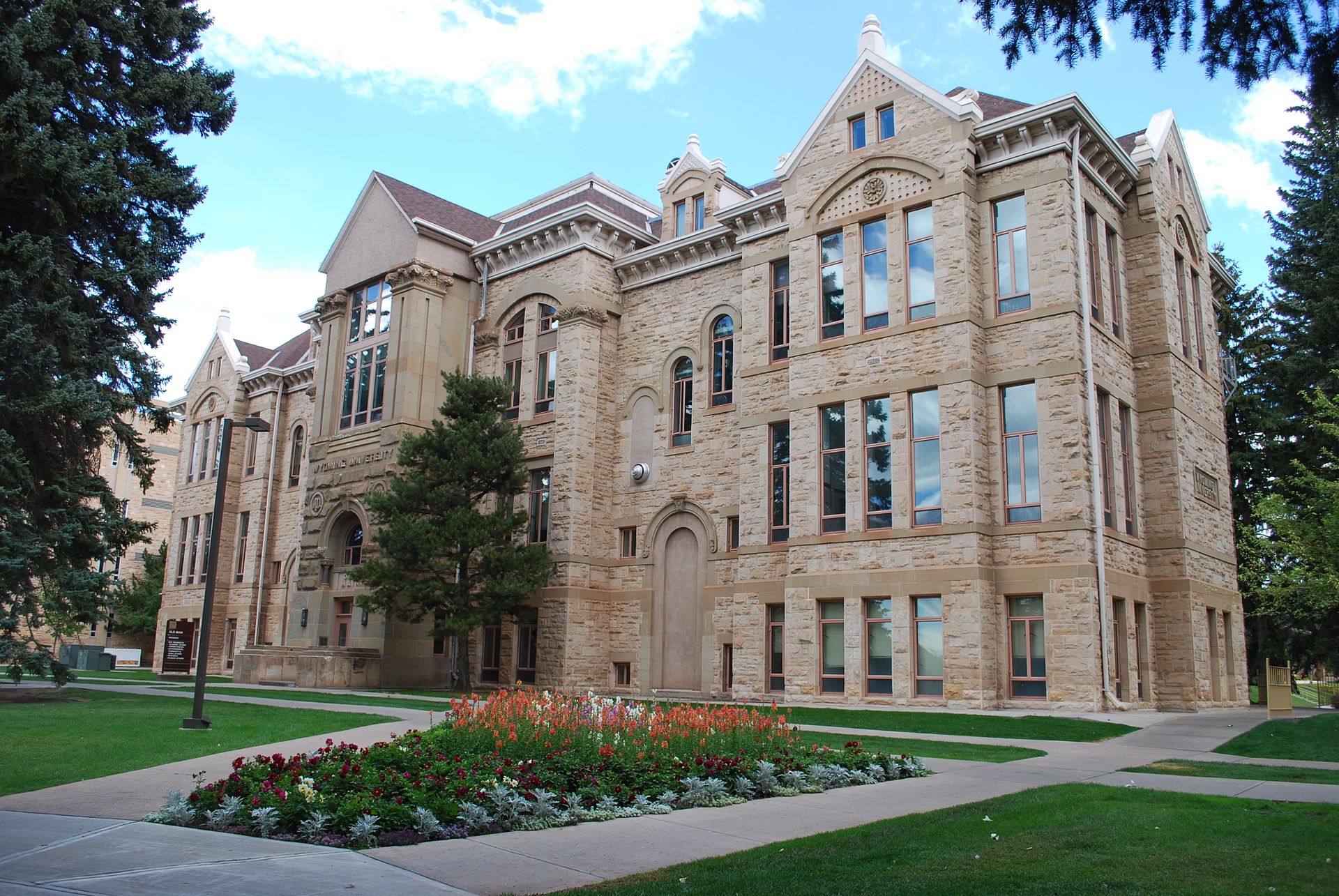 Old Main building at the University of Wyoming in Laramie, a Romanesque Revival sandstone building with a central clock tower, the original 1886 campus structure.